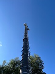 A mobile radio tower in front of a blue sky
