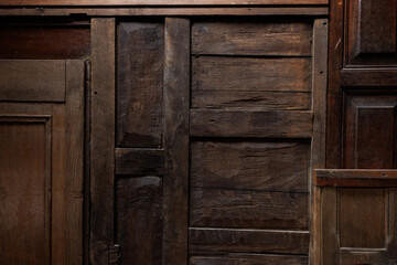 A collection of wooden panels with a worn and aged appearance. Concept of nostalgia and history, as the wood has been weathered and aged over time