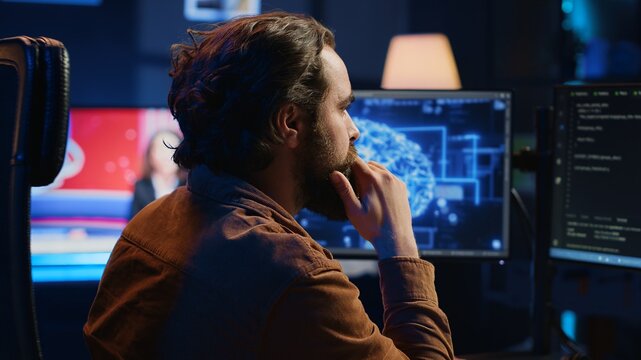 Computer scientist writes code on PC to visualize artificial intelligence neural networks. Remote IT worker runs AI script for information processing from personal office, camera A