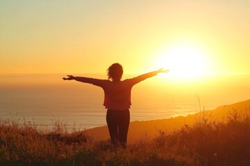 Woman with Outstretched Arms Standing on a Grassy Hill Overlooking the Ocean at Sunrise, Bathed in Warm Golden Light, Capturing a Serene and Joyful Moment of Freedom and Nature's Beauty