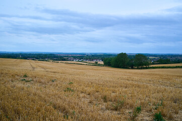 View over valley of harvested field
