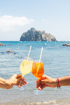 woman with spritz cocktail on the beach italian summer