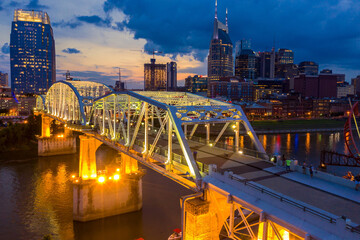 The John Seigenthaler Pedestrian Bridge crossing the Cumberaland river and downtown Nashville at...