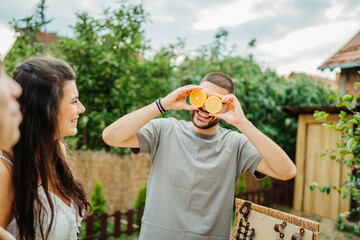 Obraz premium Group of three friends or family having picnic in backyard or garden
