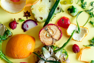 a variety of fruits and vegetables food waste on-a-yellow surface