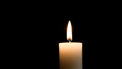 Single Candle Flame in Darkness