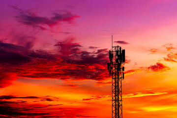 Telecommunication towers with colorful sky as a backdrop in the morning and sunlight reflecting off clouds create a stunning and mesmerizing light effect. Concept of innovation, technology and environ