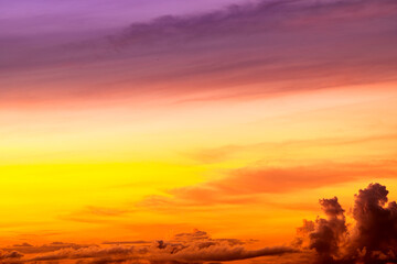Beautiful colorful sky background in the morning with rising sun reflecting off the clouds creating...
