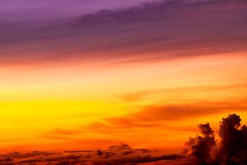 Beautiful colorful sky background in the morning with rising sun reflecting off the clouds creating a stunning and mesmerizing light effect.