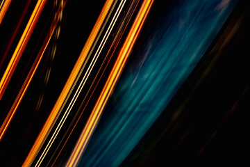 A blurry image of a black background with orange and blue lines. The image has a dreamy, surreal quality to it