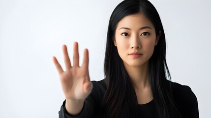 Asian Woman Showing Stop Gesture in Studio Portrait
