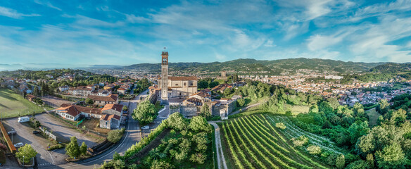 Aerial view of Arzignano castle with medieval walled town, tall clock tower, fortified gates, turrets, towers, in the middle of a vineyard in Veneto Italy  © tamas