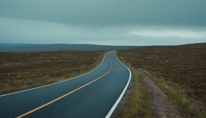 a long empty road with a white line on the side and a mountain in the background.1
