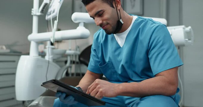 Happy man, dentist and browsing with tablet for dental appointment, schedule or research at clinic. Young, male person or orthodontist with technology for online medicine, new discovery or dentistry