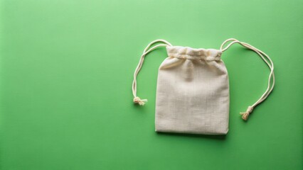 Flat lay mockup of a small eco-friendly canvas drawstring bag on green pastel background from top view, canvas, bags