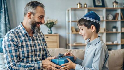 Obraz premium happy father and son with gift box sitting on sofa in living room