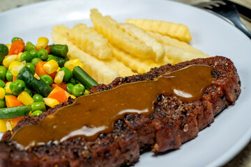 A plate of food with a piece of sirloin meat