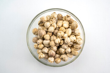 A bowl of Javanese cardamom sits on a white background