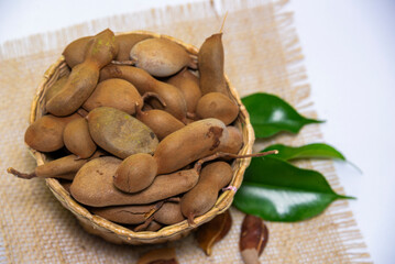Closeup of tamarind fruit in a basket 