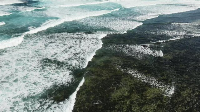 Aerial view of Playa El Mejillon with beautiful blue ocean and tranquil waves, Corralejo, Fuerteventura, Spain.