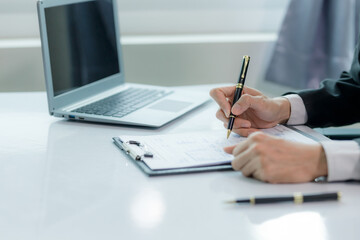 A salesperson explaining the features of a house to a client, aiming to close the sale and finalize the contract.