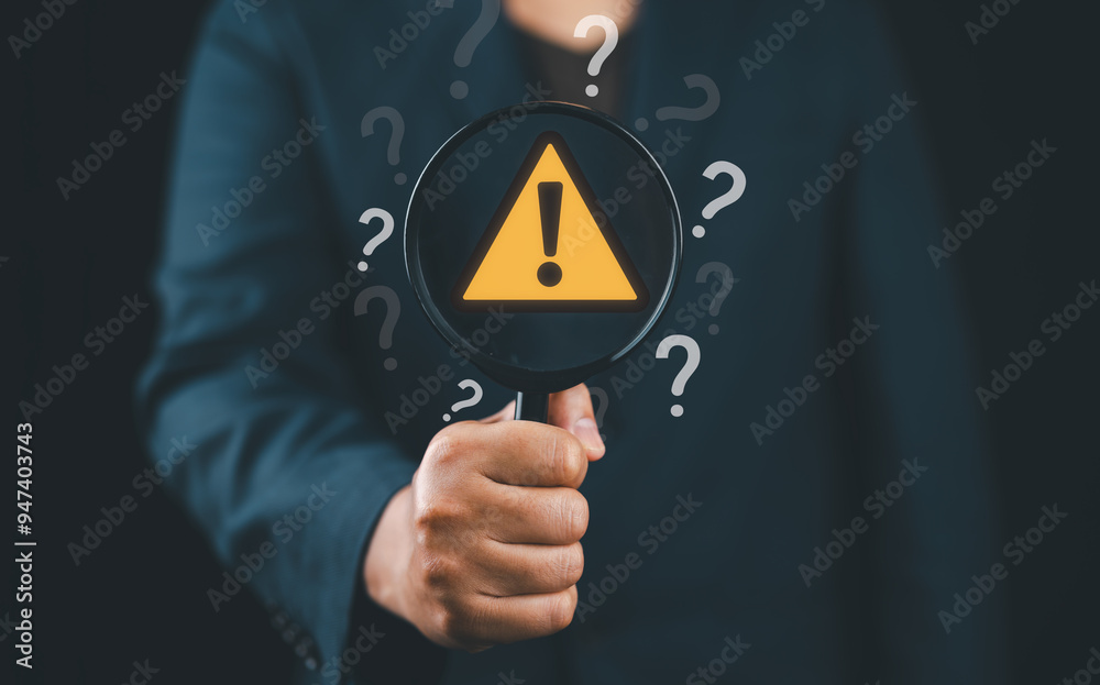 Poster Hand holding magnifier glass with yellow triangle caution warning sign and question mark for notification error and maintenance concept.