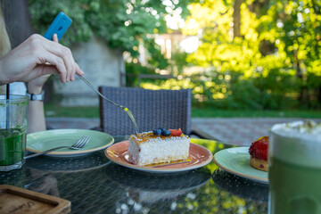 A person is eating a piece of cake with a fork