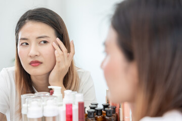 Young woman asian are worried about faces Dermatology and allergic to steroids in cosmetics. sensitive skin, red face from sunburn, acne, allergic to chemicals, rash on face. skin problems and beauty