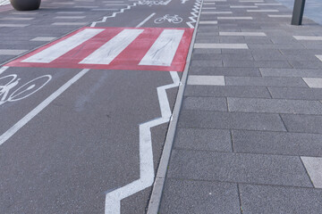 A red and white striped line is painted on the road