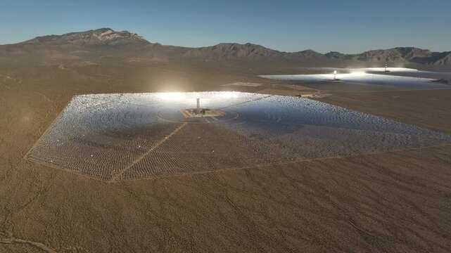 Aerial view of ivanpah solar plant in the desert with solar panels and mountains under a blue sky, Calada, California, United States.