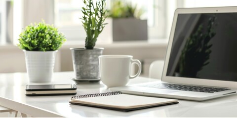 Fototapeta premium A modern Minimalist home office setup with a laptop Notebook And coffee cup on a clean white desk