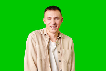 Young Man With Short Hair Smiling Against a Bright Green Background