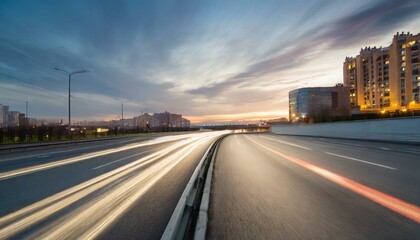 wide angle photo of a city road with a speed blur in the evening.road, highway, traffic, car, travel, sky, asphalt, transportation, city, freeway, transport, driving, speed, 