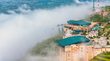 Ba Den mountain tourist area. The longest cable car at Ba Den mountain in cloud sky. Below is forest. © Hien Phung