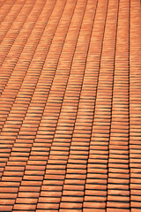 Roof top view. Red tile. The pattern of roof tile. Orange tile roof, abstract background. Roofing texture. Red corrugated tile element of roof. Seamless pattern.
