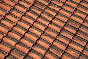 Roof top view. Red tile. The pattern of roof tile. Orange tile roof, abstract background. Roofing texture. Red corrugated tile element of roof. Seamless pattern.