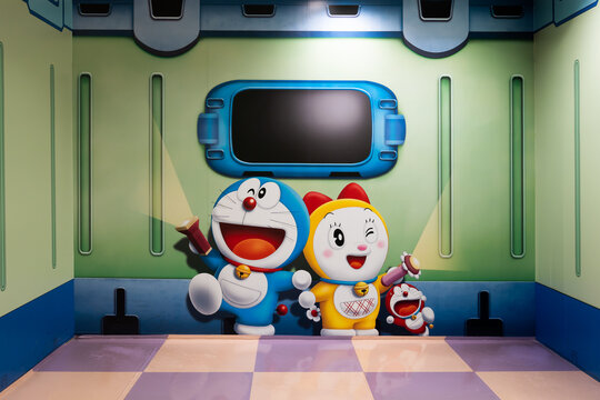 JAPAN - JUL 15, 2024: Colorful mural of Doraemon, Dorami and Mini Dora holding small light and big flashlight in a playful futuristic with joy at WakuWaku Sky Park, Chitose, Hokkaido