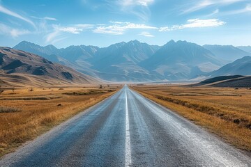 Empty Asphalt Road Leading Through Mountain Valley Under Blue Sky