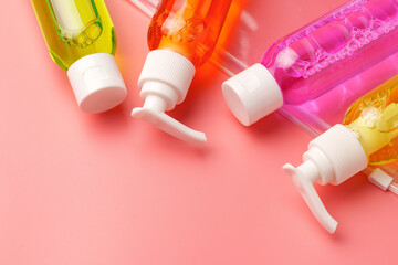 Clear Plastic Bag Containing Travel-Sized Toiletries on Pink Background
