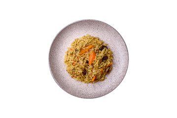 Delicious fresh pilaf with rice, carrots, meat, onions, spices and berries