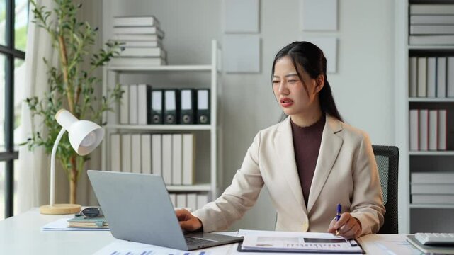 Businesswoman has chest pain caused by heart disease, heart attack, leaky heart, and coronary artery disease. This is due to working hard on a laptop. health problems concept.