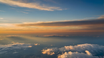 Fototapeta premium Aerial View of Sunset Over a Sea of Clouds