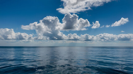 Obraz premium White Clouds Over a Calm Blue Ocean