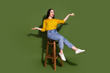 Full length photo of cheerful impressed lady dressed yellow blouse sitting stool empty space...