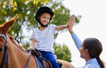Woman, girl and equestrian for horse riding with high five, learning and excited at ranch in summer. People, teacher and child with support, cheers and celebration for progress at farm in Argentina