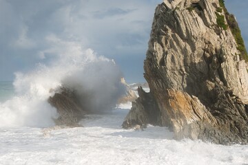 Heavy Waves Crashing on the white rock at new zealands coast