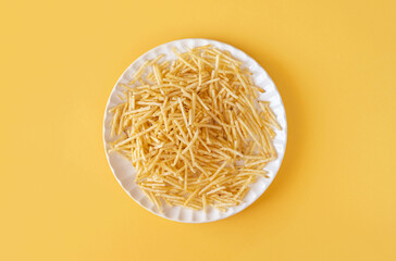 potato straw on yellow background