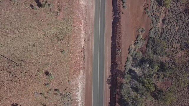Aerial view of road train on Stuart Highway through vast desert landscape, Wilora, Australia.