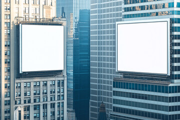Obraz premium Two large white billboards are on the side of a tall building in a city