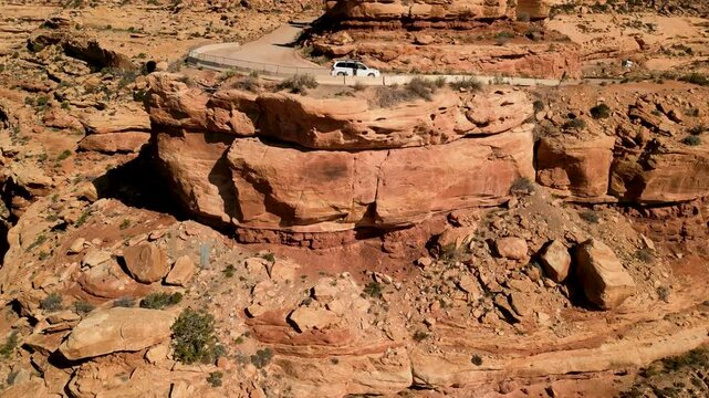 Aerial view of the majestic Moki Dugway canyon with rugged cliffs and a scenic road, Mexican Hat, United States.
